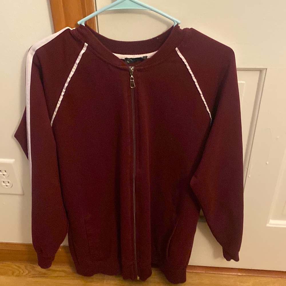 A red never been used adidas jacket form Dubai.